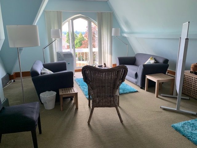 A welcoming blue therapy room